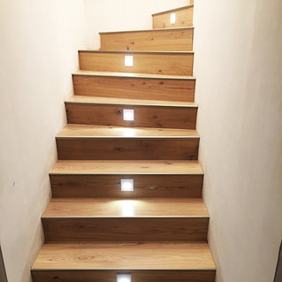 Eine Holztreppe mit integrierten Leuchten in den Stufen